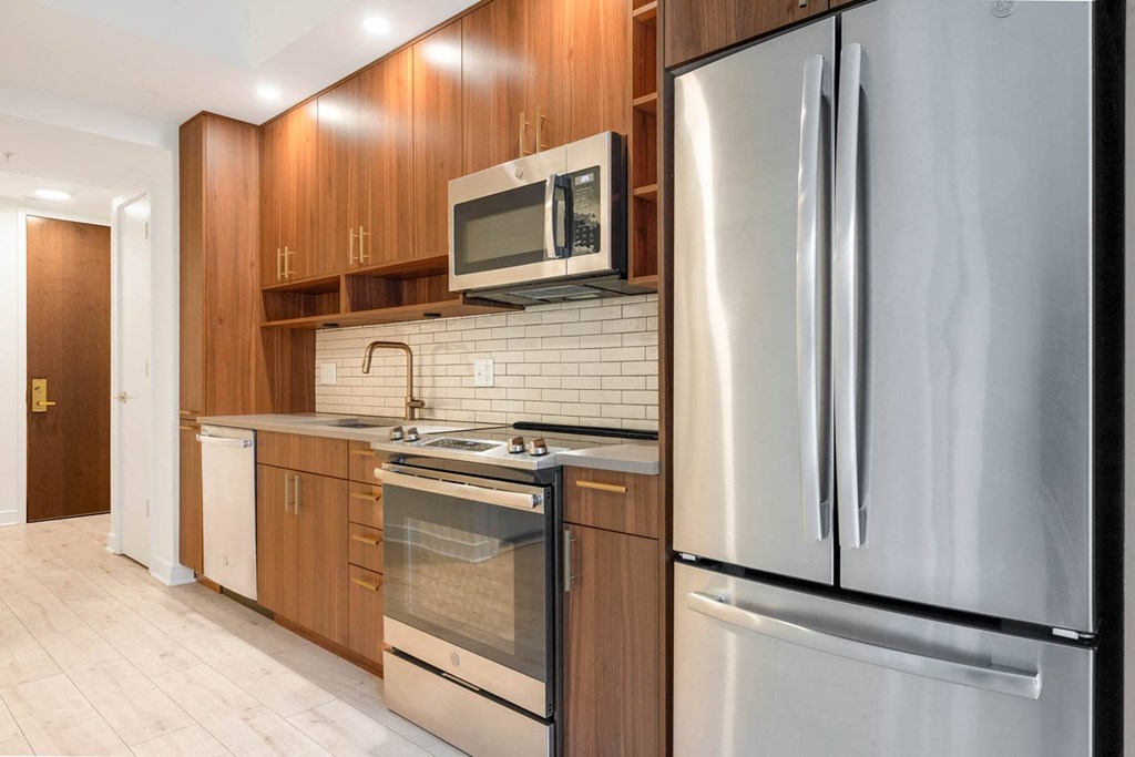 a kitchen with stainless steel appliances and wooden cabinets