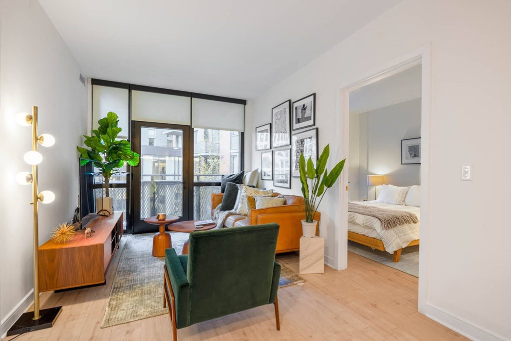 a living room with a couch and a bed in a bedroom