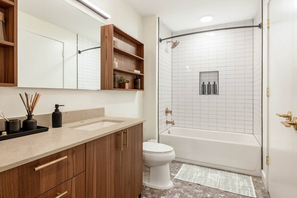 a bathroom with a toilet and a shower and a sink