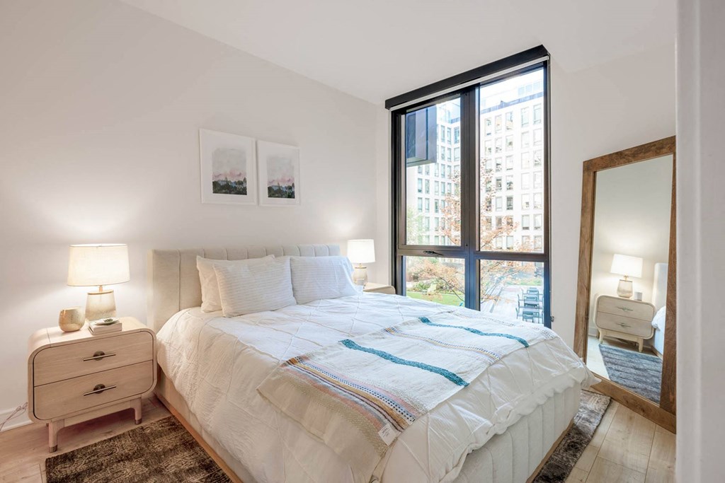 a bedroom with a large bed and a large window