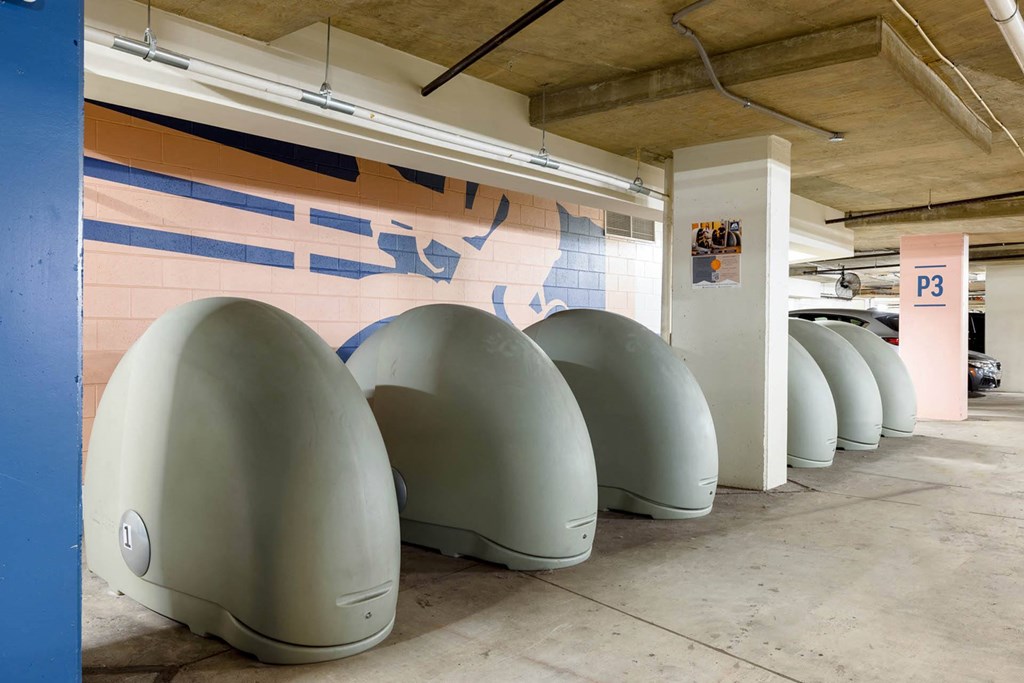 a row of white toilets in a parking garage
