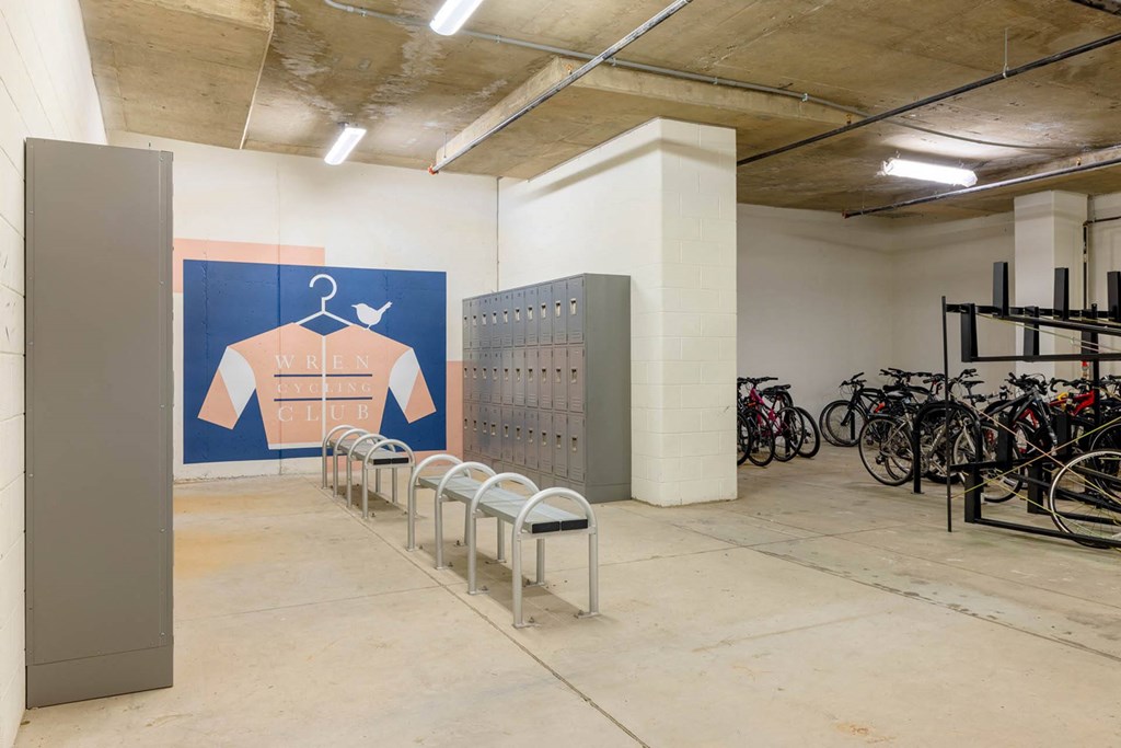 a group of bikes parked in a room with a wall with a shirt on it