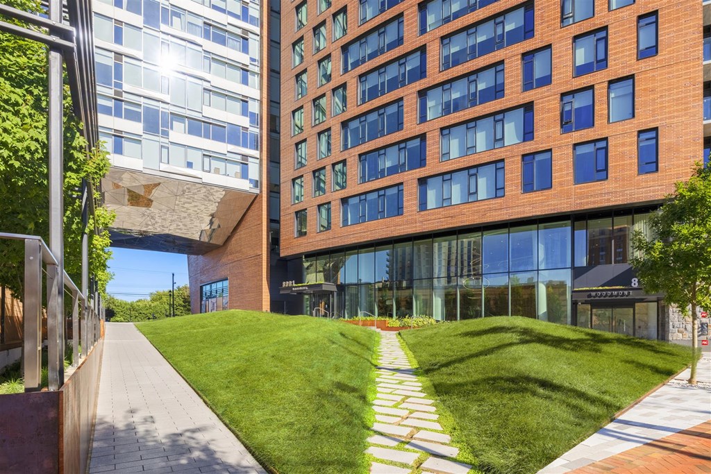 a walkway in front of a tall building