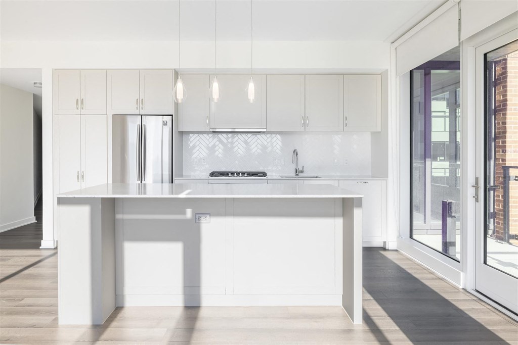 a white kitchen with white cabinets and a white counter top