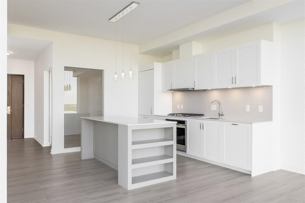 a kitchen with white cabinets and a white counter top