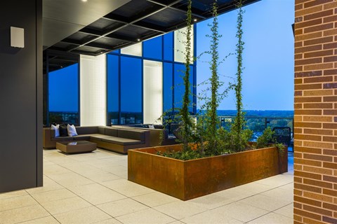 a terrace with seating and a view of the city