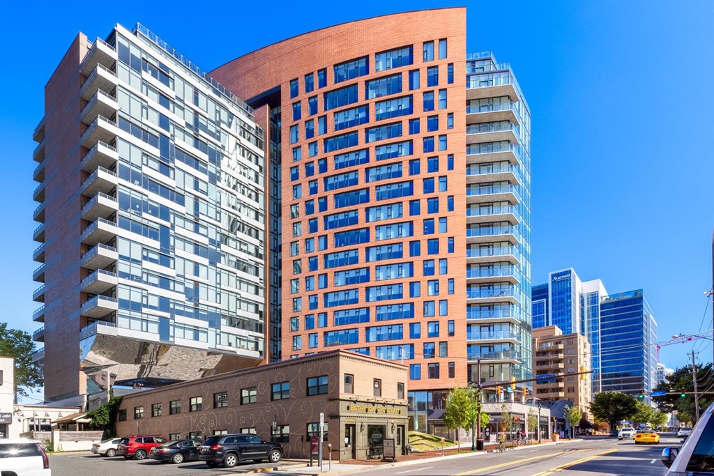 a view of a tall building in a city with other tall buildings