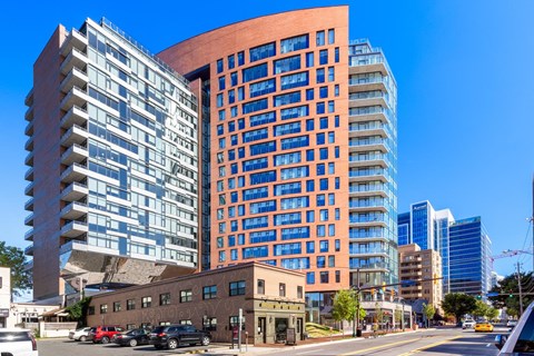 a view of a tall building in a city with other tall buildings