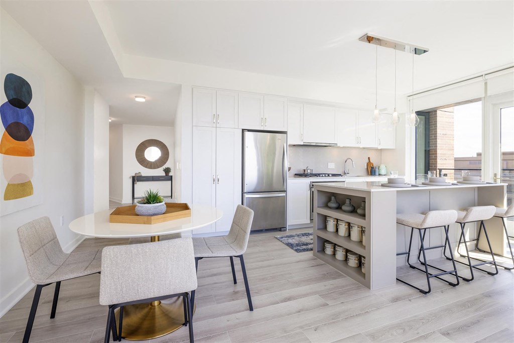 an open kitchen and dining area with a table and chairs