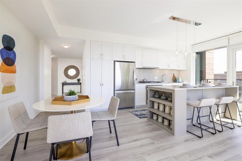 an open kitchen and dining area with a table and chairs