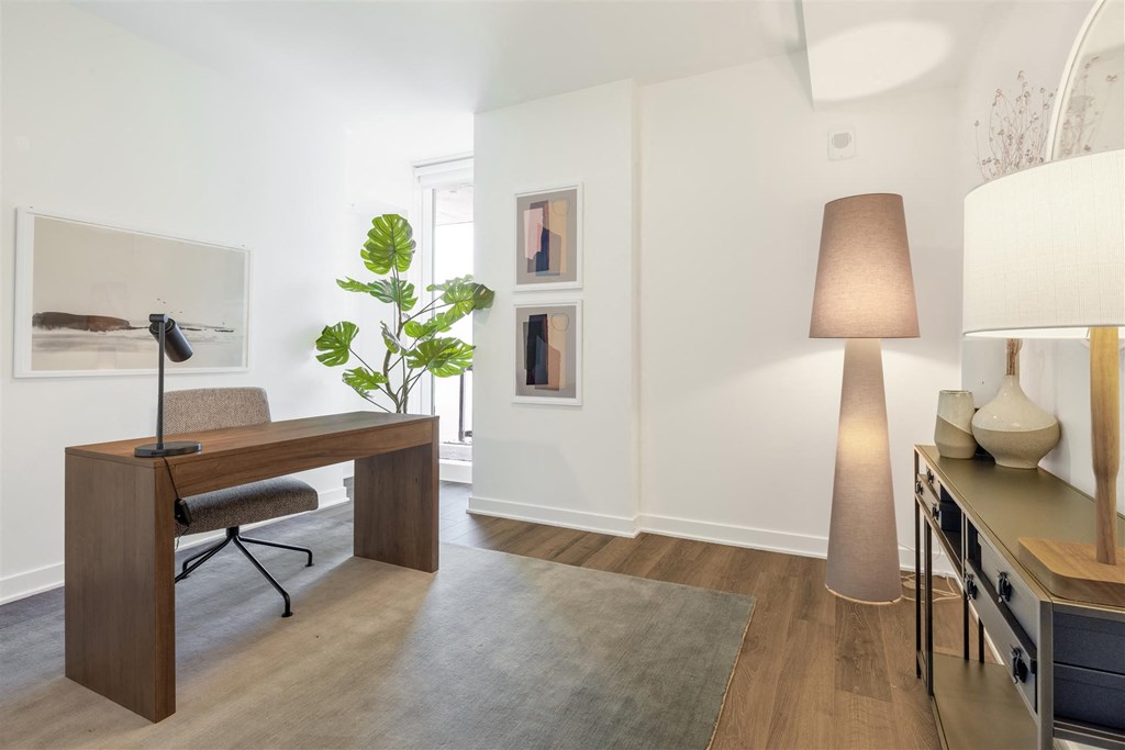 a home office with a desk and a large lamp