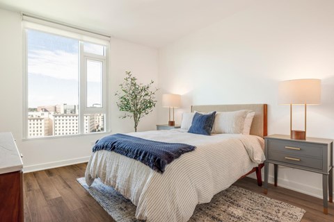 a bedroom with a bed and a window