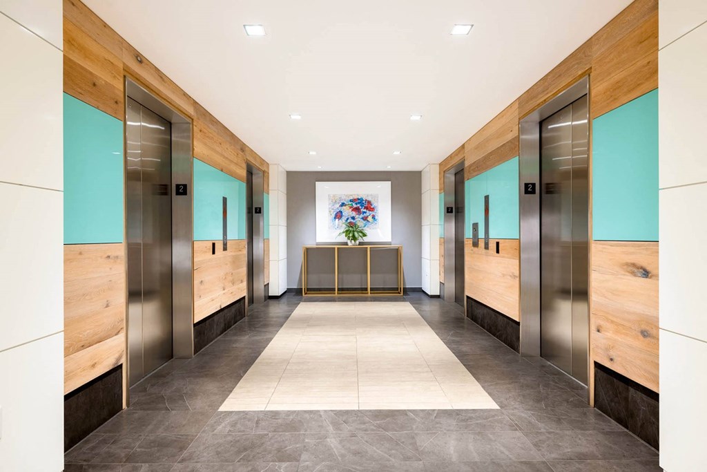 a lobby with elevators and a table in the middle