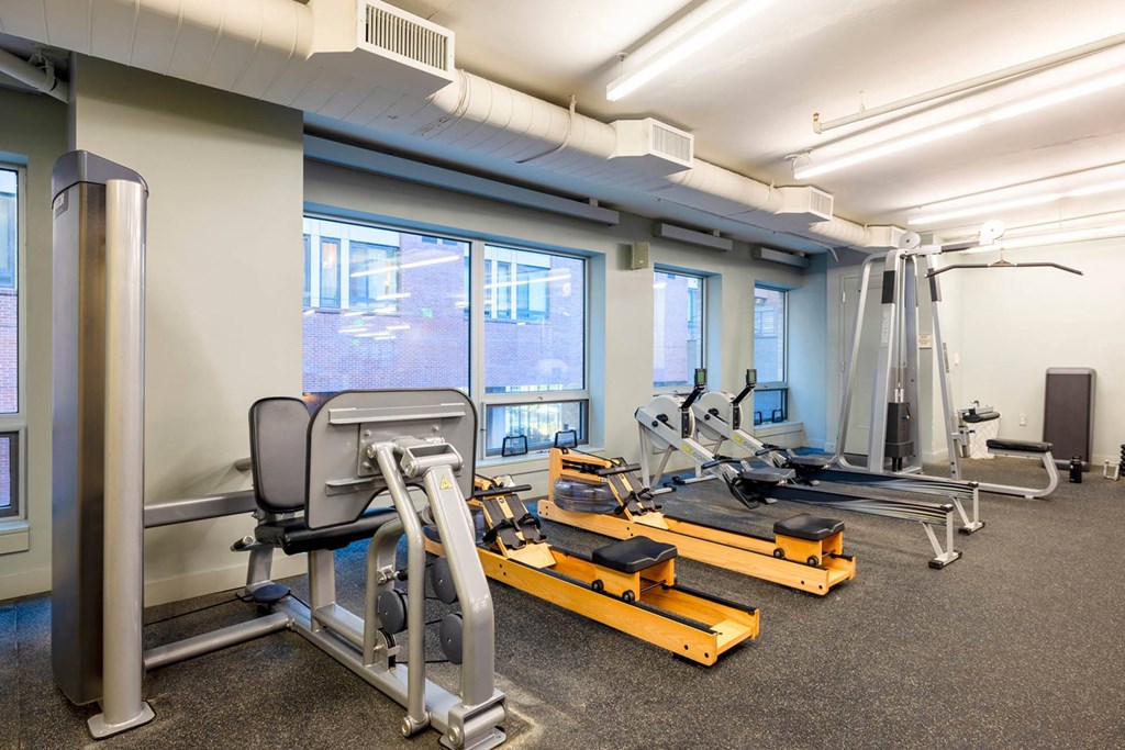 a gym with various machines and weights in a room