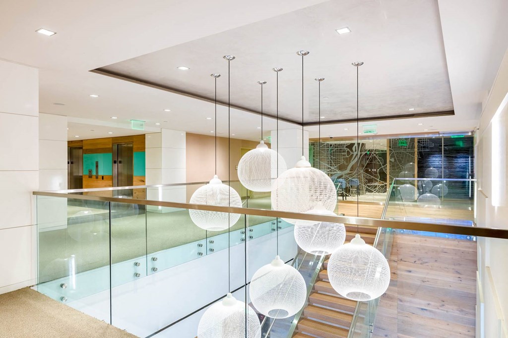 a dining room with a glass table and chairs