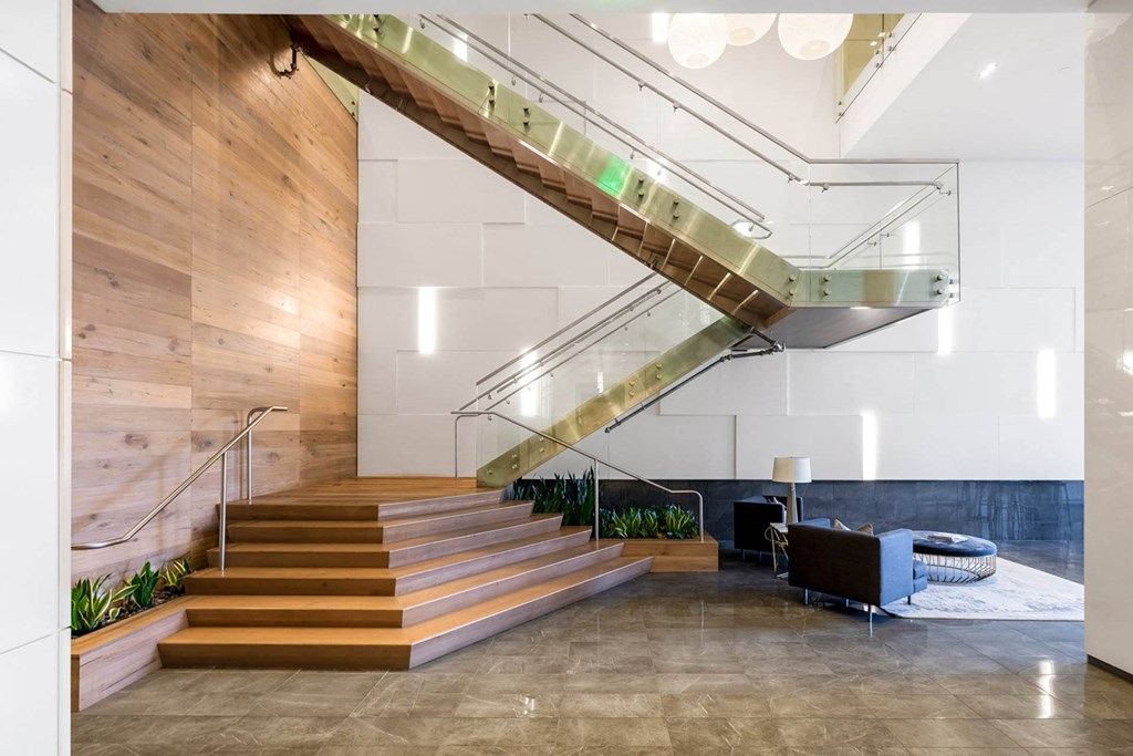 a staircase in the lobby of a building with wooden stairs