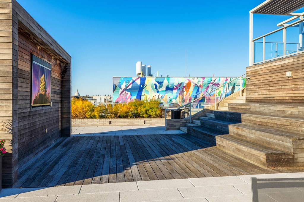 a set of stairs with a mural on the side of a building