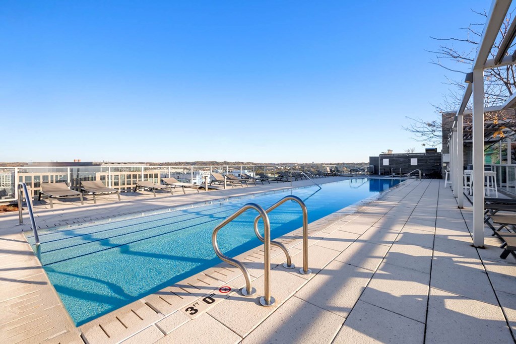 a swimming pool with a ladder on the side of a building