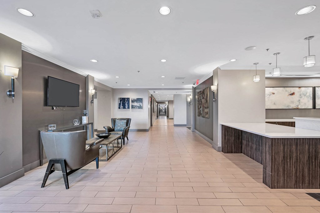 a lobby with a table and chairs and a television