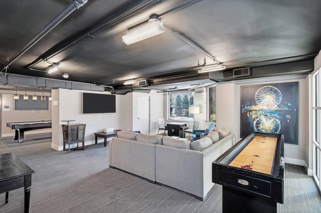 a living room with a pool table and a television