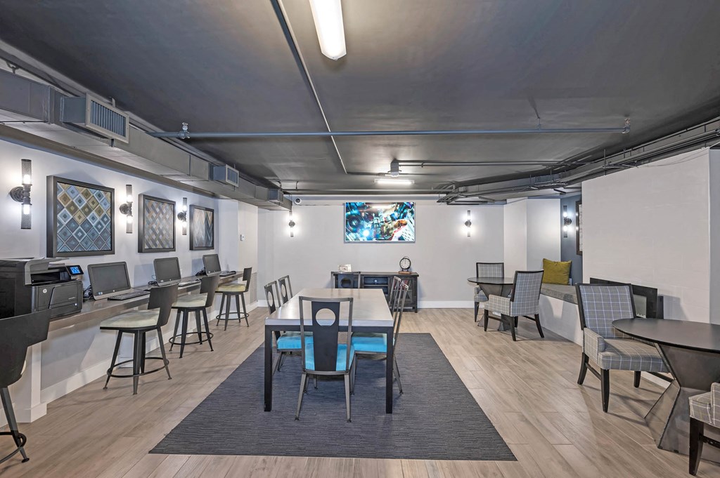 a dining room with tables and chairs and a television