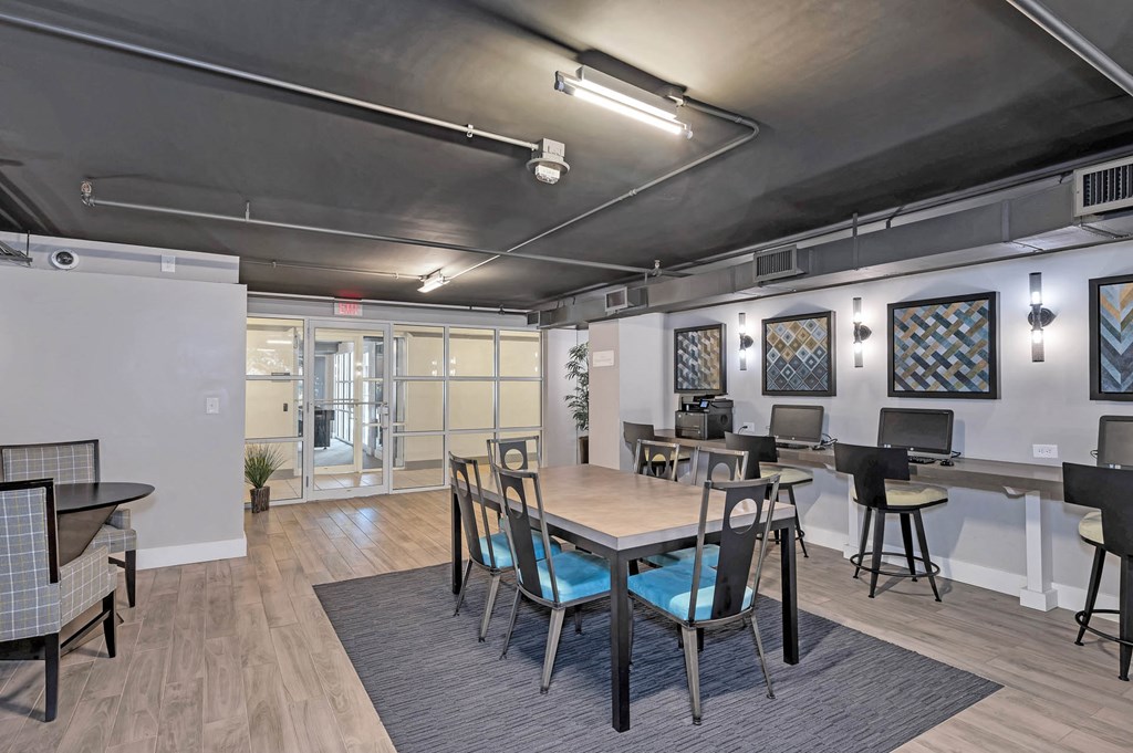 a dining room with a table and chairs in an open office space