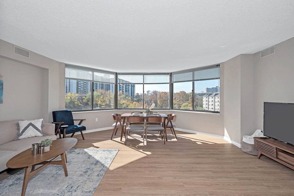 a living room with a table and chairs and a large window