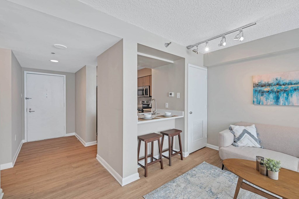 a living room and kitchen with a couch and a table