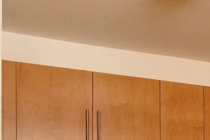 Kitchen with oven, dark counters, light cabinets, microwave, sink and refrigerator