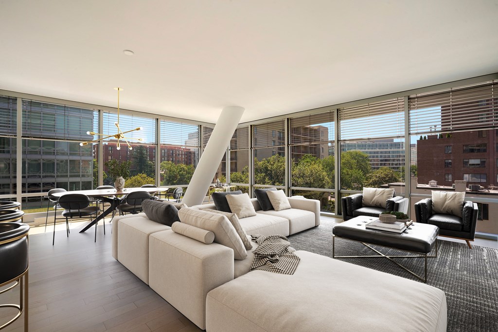a large living room with a white couch and a table