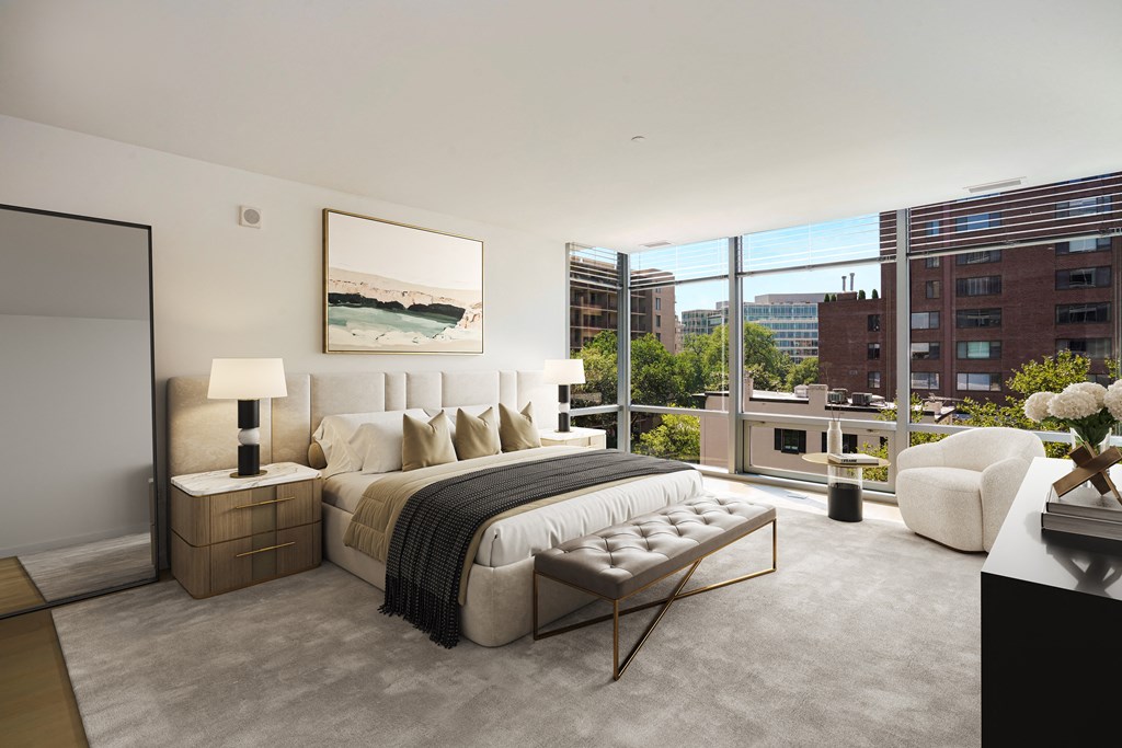 a bedroom with a bed and a large window