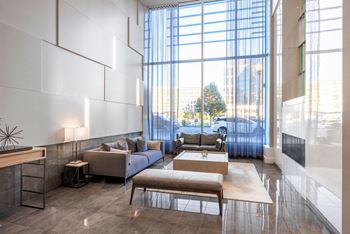 a living room with couches and a coffee table in front of a large window