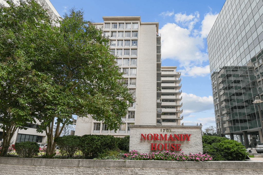 The Normandy House sign is in front of a building.