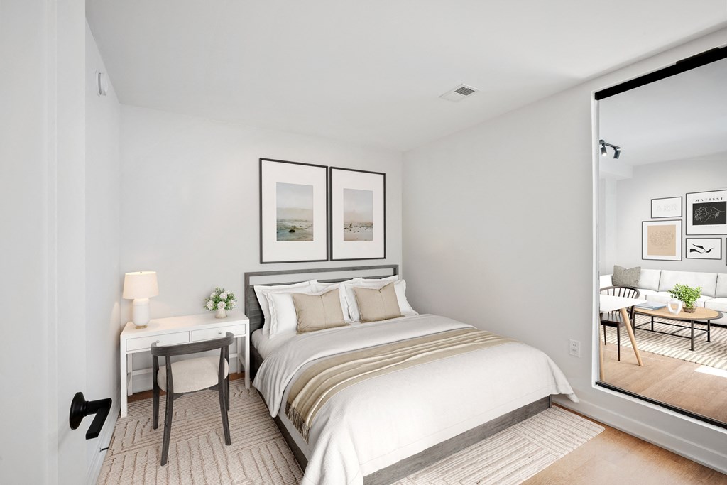 a bedroom with a large bed and a window