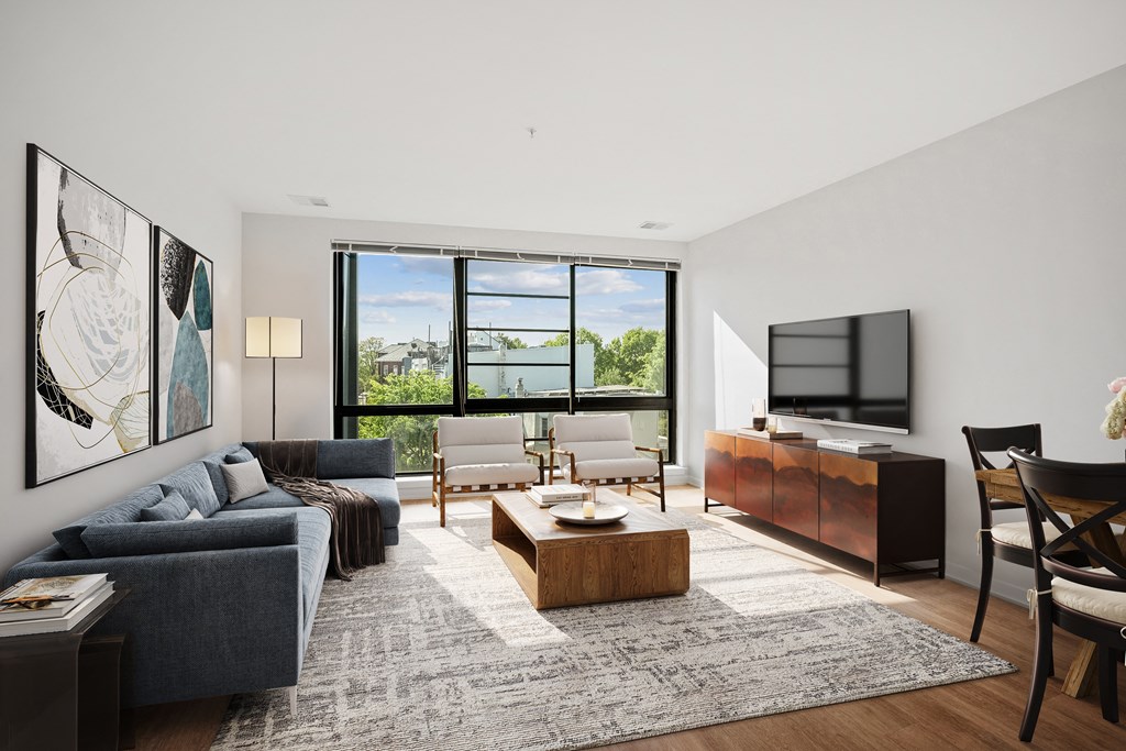 a living room with a couch and a coffee table and a television
