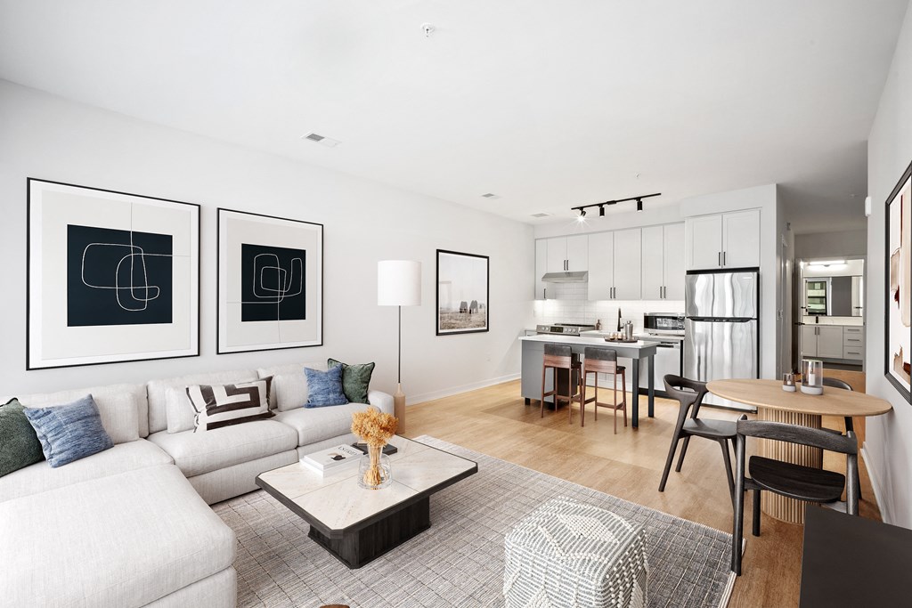 a living room with a couch and a table and a kitchen