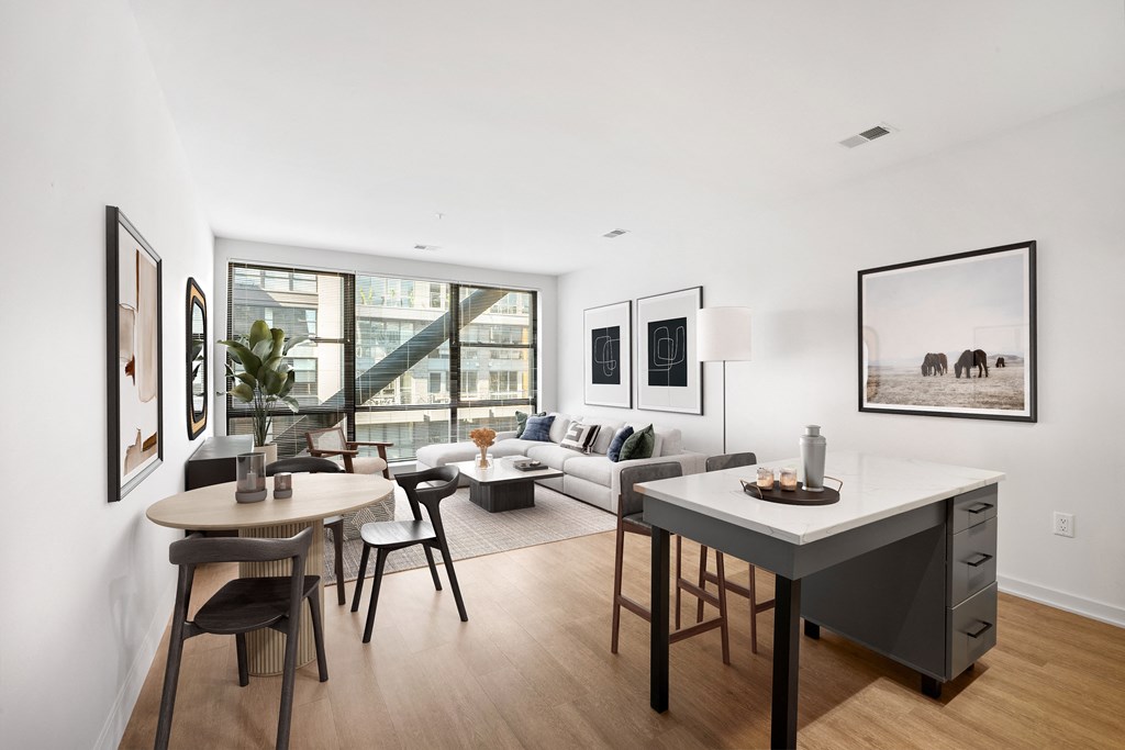 an open living room with a dining room table and a couch