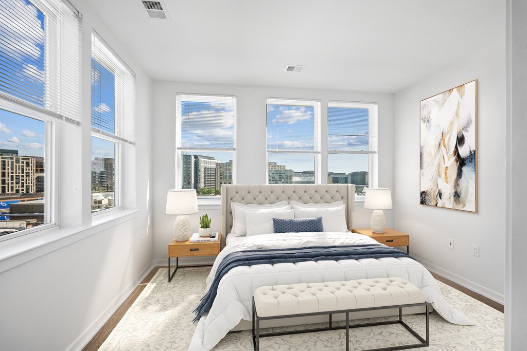 a bedroom with a bed and four windows