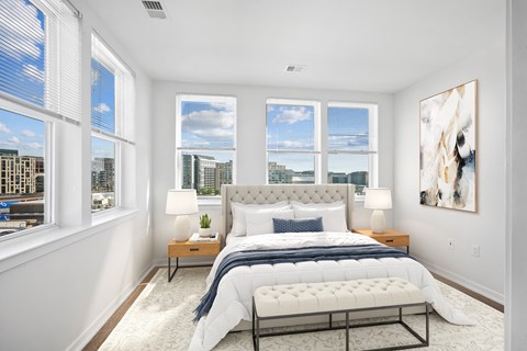 a bedroom with a bed and four windows
