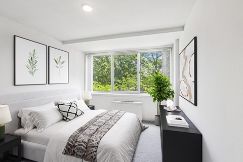 a bedroom with a bed and a large window