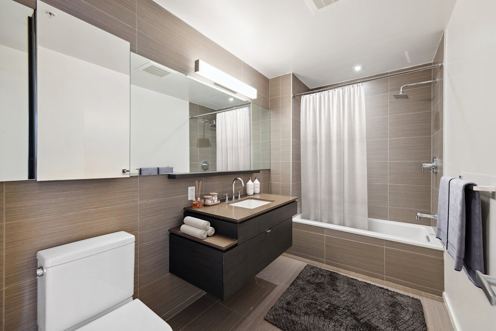 a bathroom with a sink and a toilet and a shower