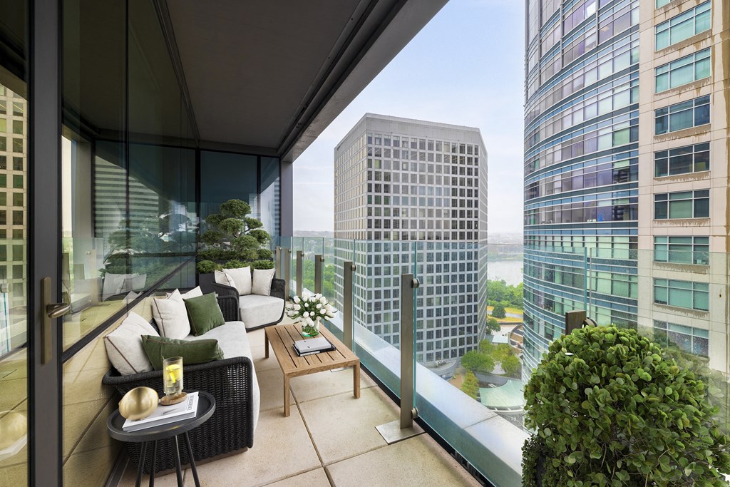 a terrace with a couch and a table on a balcony