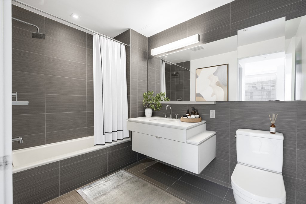 a bathroom with a toilet sink and a mirror