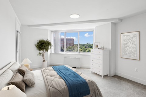 a bedroom with a bed and a window