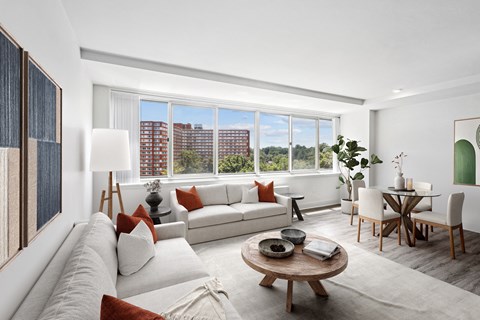 a living room with a couch and a table and a large window