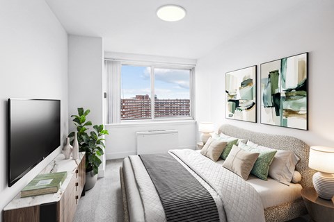 a bedroom with a large bed and a tv