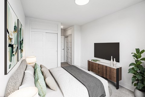 a bedroom with a large bed and a tv