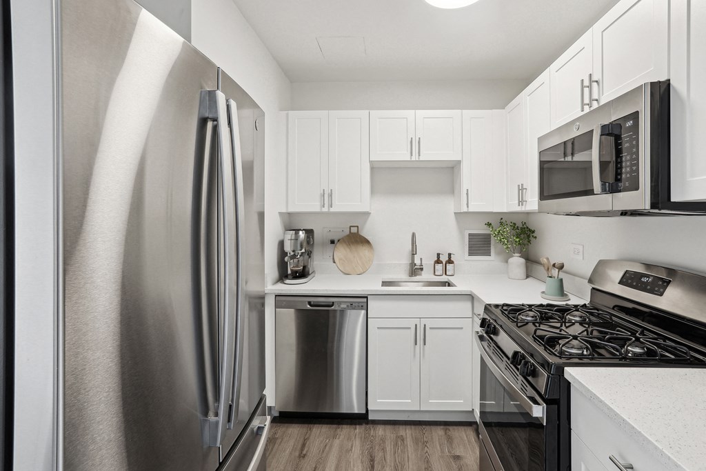 a kitchen with stainless steel appliances and white cabinets