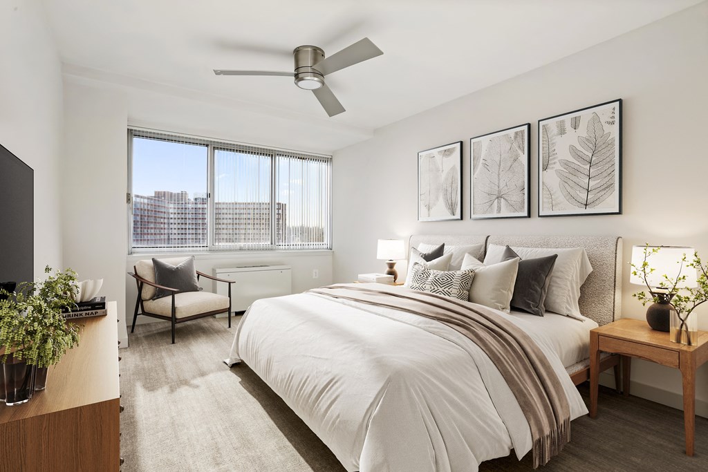 a bedroom with a large bed and a ceiling fan