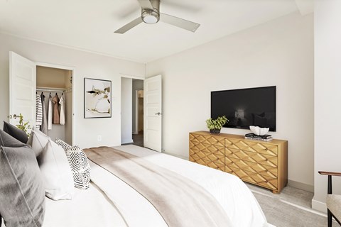 a bedroom with a large bed and a dresser